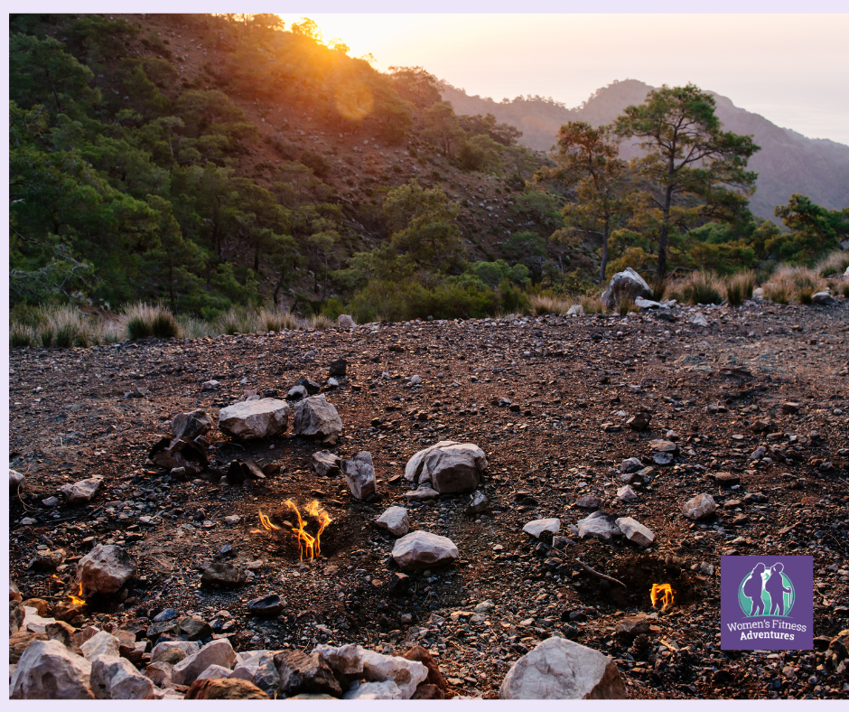 the Eternal Flames (Yanartaş) of Mount Chimaera on the Lycian Way in Turkey, with rocky terrain underfoot and flickering natural fire vents glowing from the ground