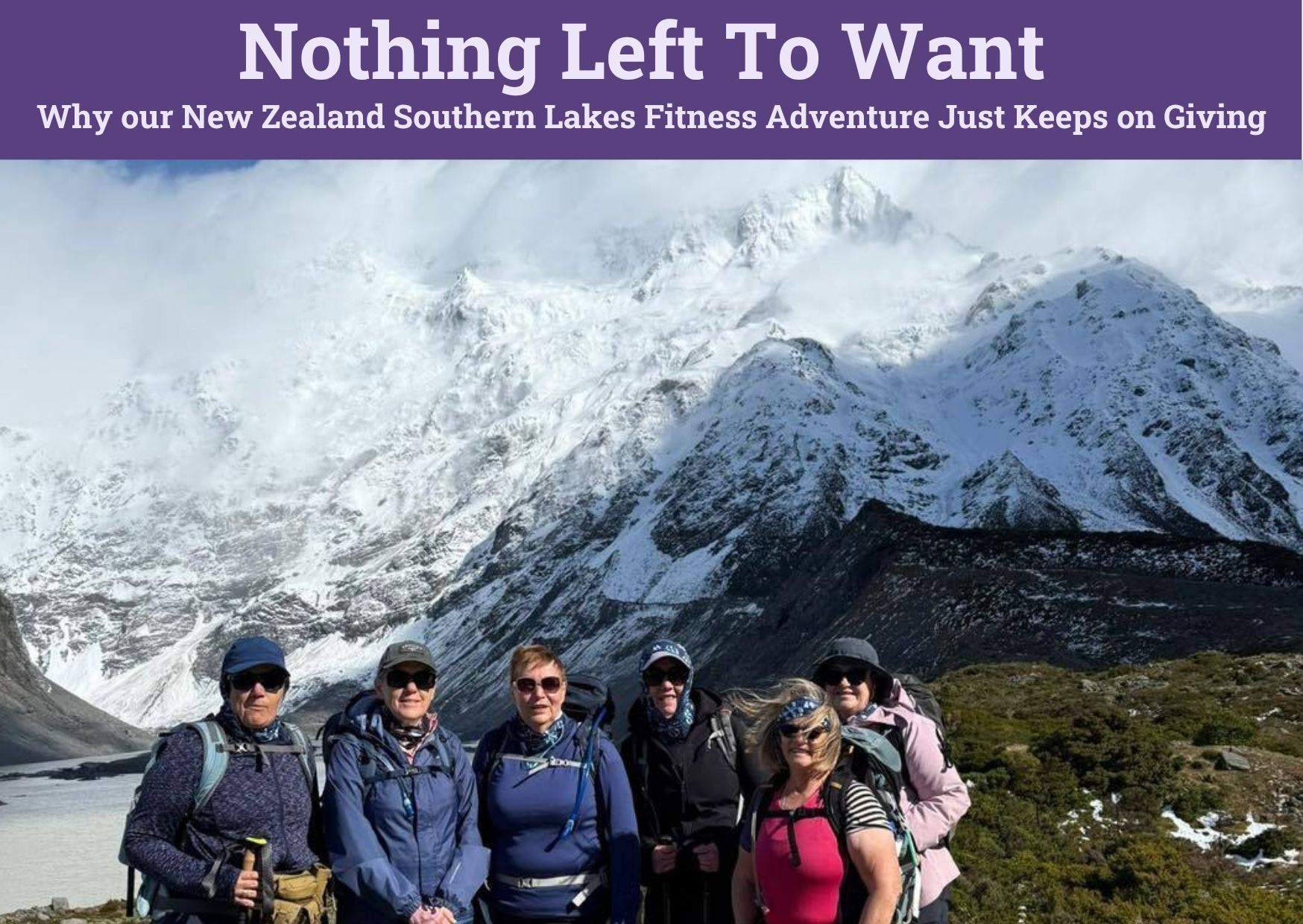 Group of hikers posing in front of snowy mountain peaks in New Zealand