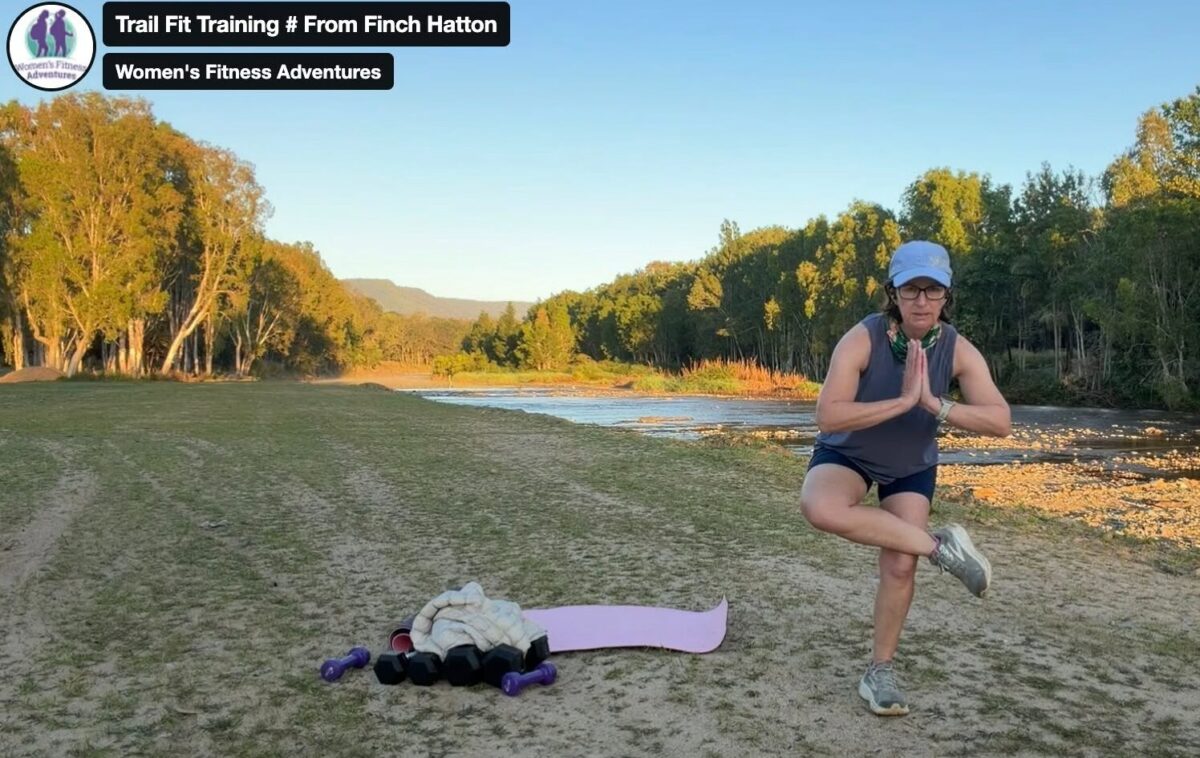 Women’s hiking fitness training by the riverbank with balance exercises